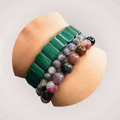 Stacked gemstone bracelets including Blue Kyanite 8mm beads, styled on wrist for promoting communication and energetic flow.
