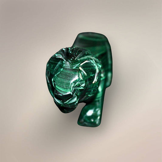 Front view of the Malachite lion carving with a defined face, carved mane, front legs, and dark green polished finish.