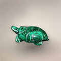 Side hero view of a Malachite turtle carving showing the domed patterned shell, extended head, and polished flippers.