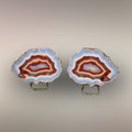 Ngabu Malawi Agate matched nodule pair with multi-color banding and quartz centers displayed on stands.