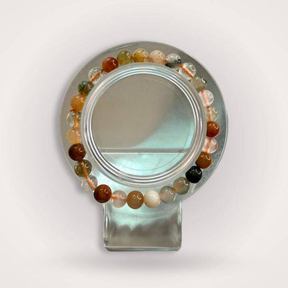 Mixed Rutile Quartz 6mm beaded bracelet displayed on a clear stand, showcasing multicolored translucent beads for clarity and intuitive flow.