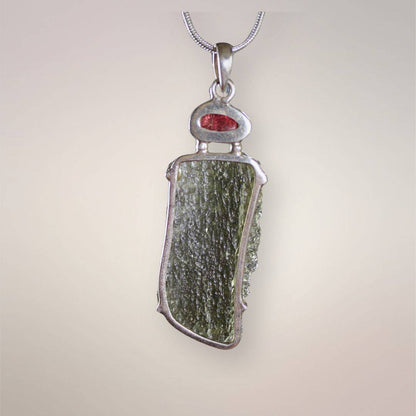 Back view of Czech Republic Angel Chime Moldavite and Brazilian rubellite pendant in .925 silver, showing the natural green surface and open setting.