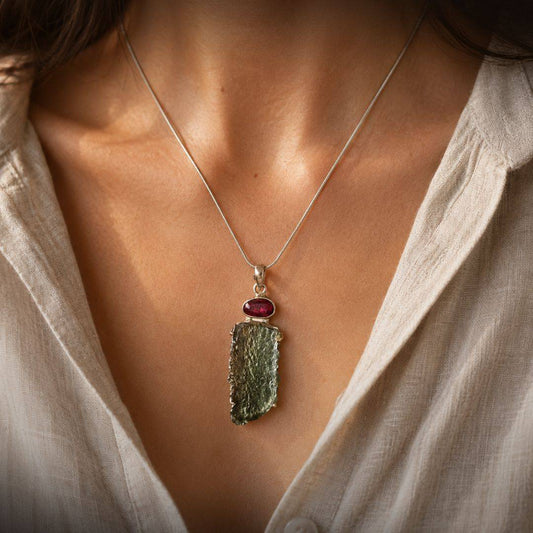 Angel Chime Moldavite and rubellite pendant worn at the center of the chest on a fine silver chain.