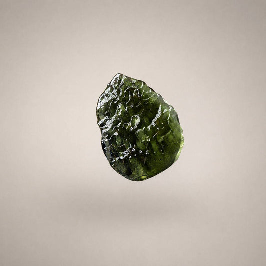 Close-up of Czech Republic Moldavite with olive-green translucence, rounded ridges, grooves, and a naturally sculpted glass surface.