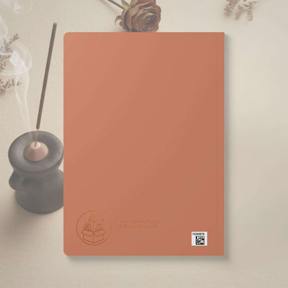 Coral notebook with a brand logo on a light background