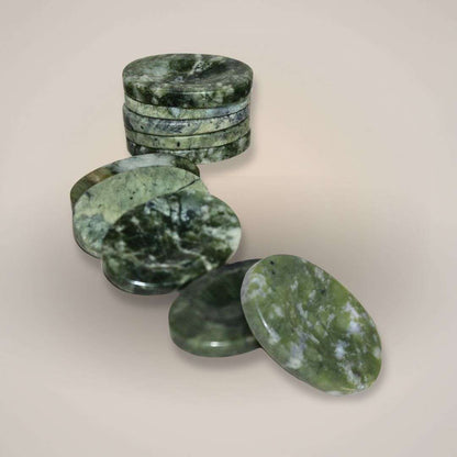 Polished nephrite gemstone palm stone held in hand for daily support and calm