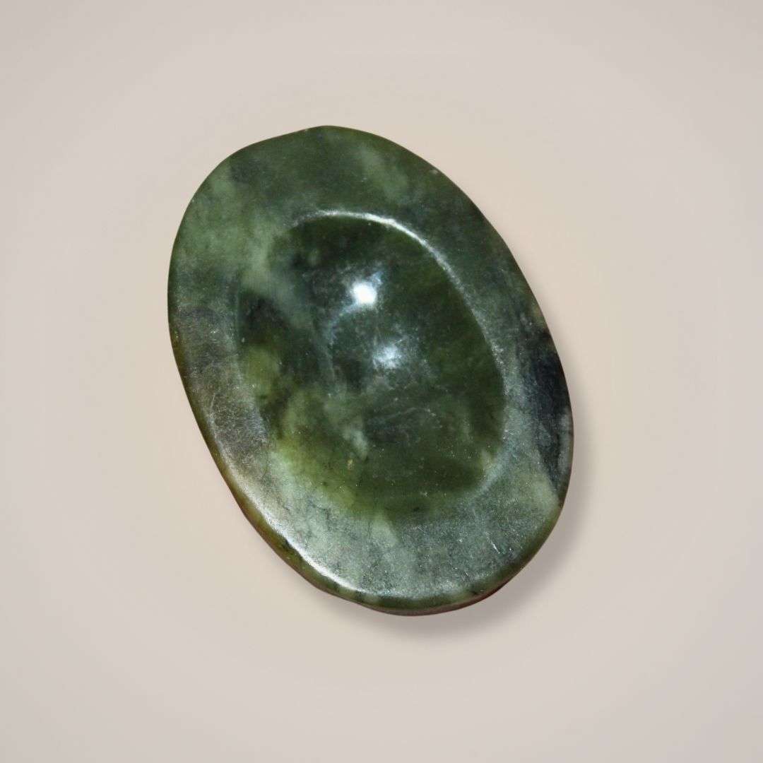 Polished nephrite palm stone from Pakistan with a worry stone smooth thumb groove for calm and balance
