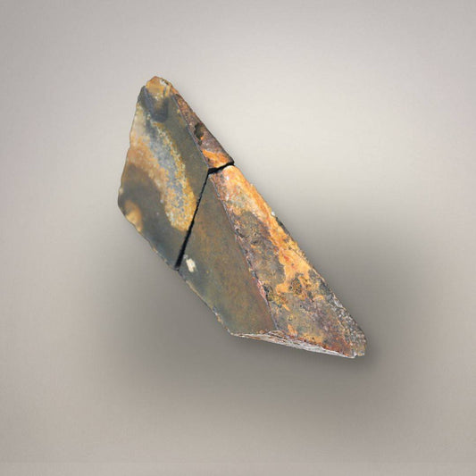 Natural polyhedral agate nodule showing flat-sided angular formation and rough exterior rind