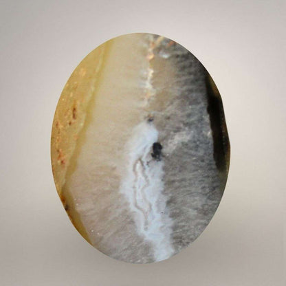 Close view showing honey agate texture and dark inclusions