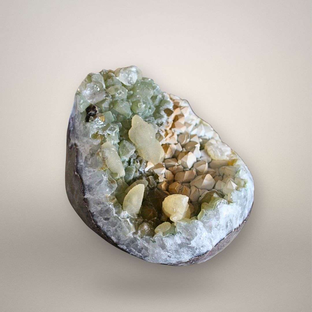 Depth view into quartz geode cavity highlighting druzy quartz boundary and multi-phase calcite growth
