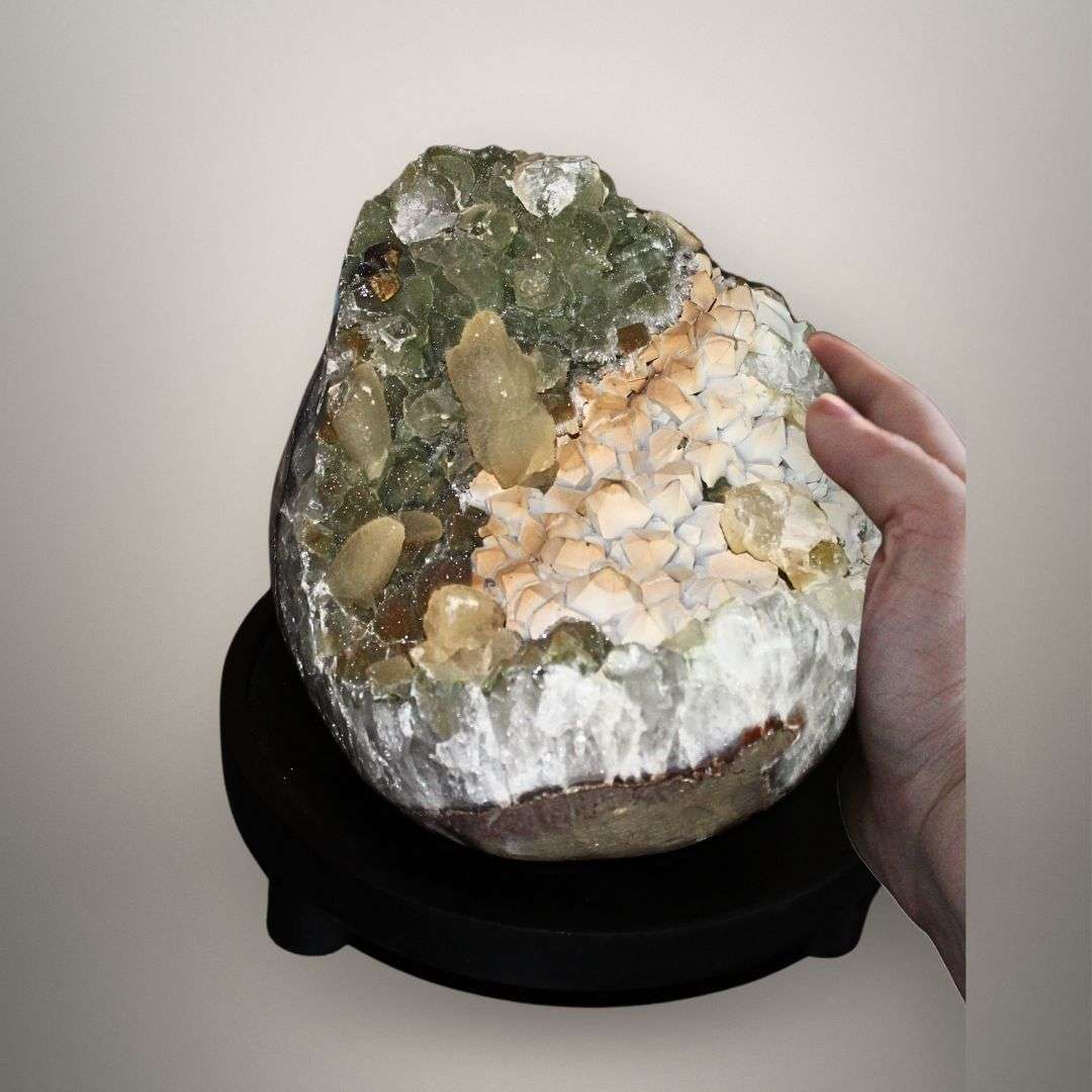 Cabinet-size quartz geode with calcite and chlorite quartz shown on stand for scale and display reference