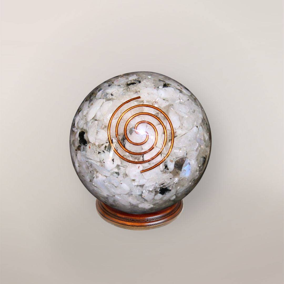 Rainbow Moonstone orgonite sphere with Indian Rainbow Moonstone chips, copper spiral, copper flakes, and wood display stand