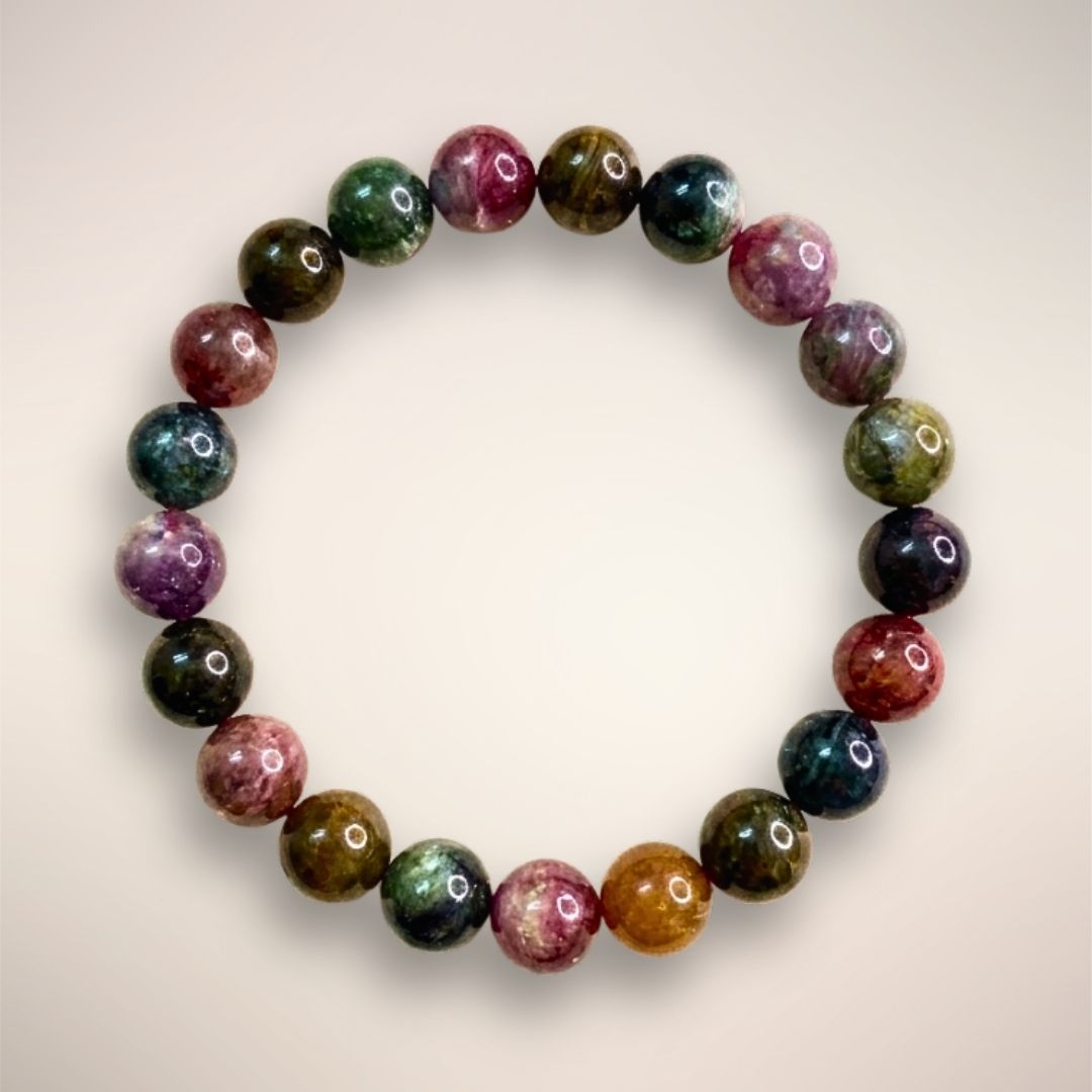 Rainbow Tourmaline Beaded Bracelet 9mm displayed on a clear stand, showcasing multicolored polished beads 