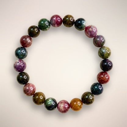 Rainbow Tourmaline Beaded Bracelet 9mm displayed on a clear stand, showcasing multicolored polished beads 