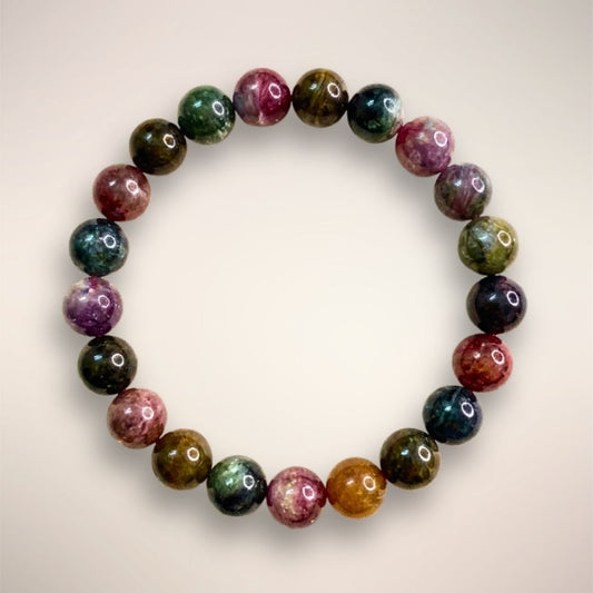 Rainbow Tourmaline Beaded Bracelet 9mm displayed on a clear stand, showcasing multicolored polished beads 