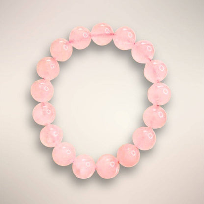 8mm Rose Quartz beads, emphasizing their smooth finish and gentle pink tone
