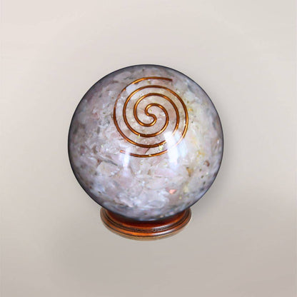 Rose Quartz orgonite sphere with Brazilian Rose Quartz chips, copper spiral, copper flakes, and wood display stand