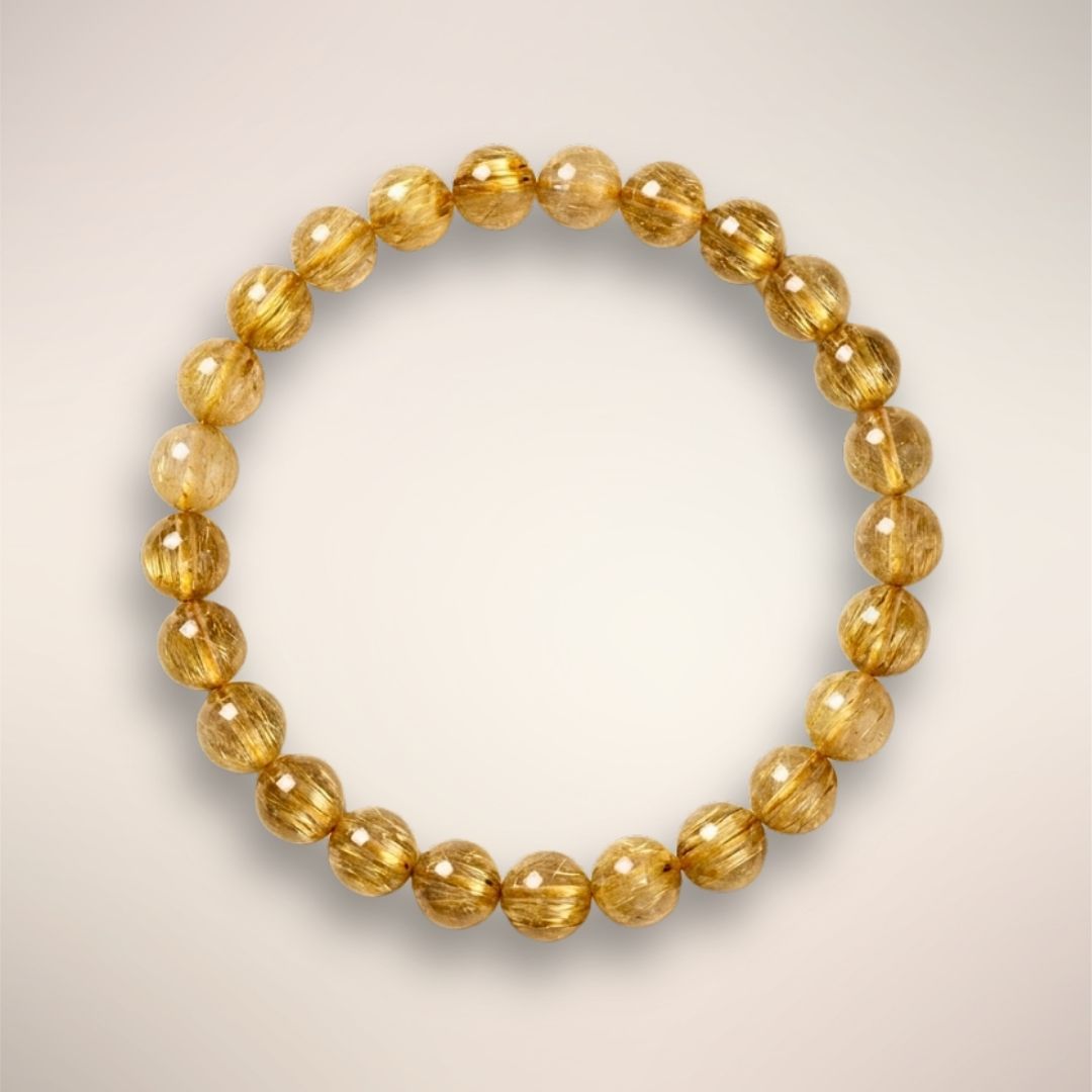 Golden Rutile Quartz 6mm beaded bracelet displayed on a clear stand, for clarity and intuitive flow.