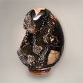 Angled view of Septarian Dragon Egg from Madagascar highlighting the open sparkling druzy cavity and polished outer surface.