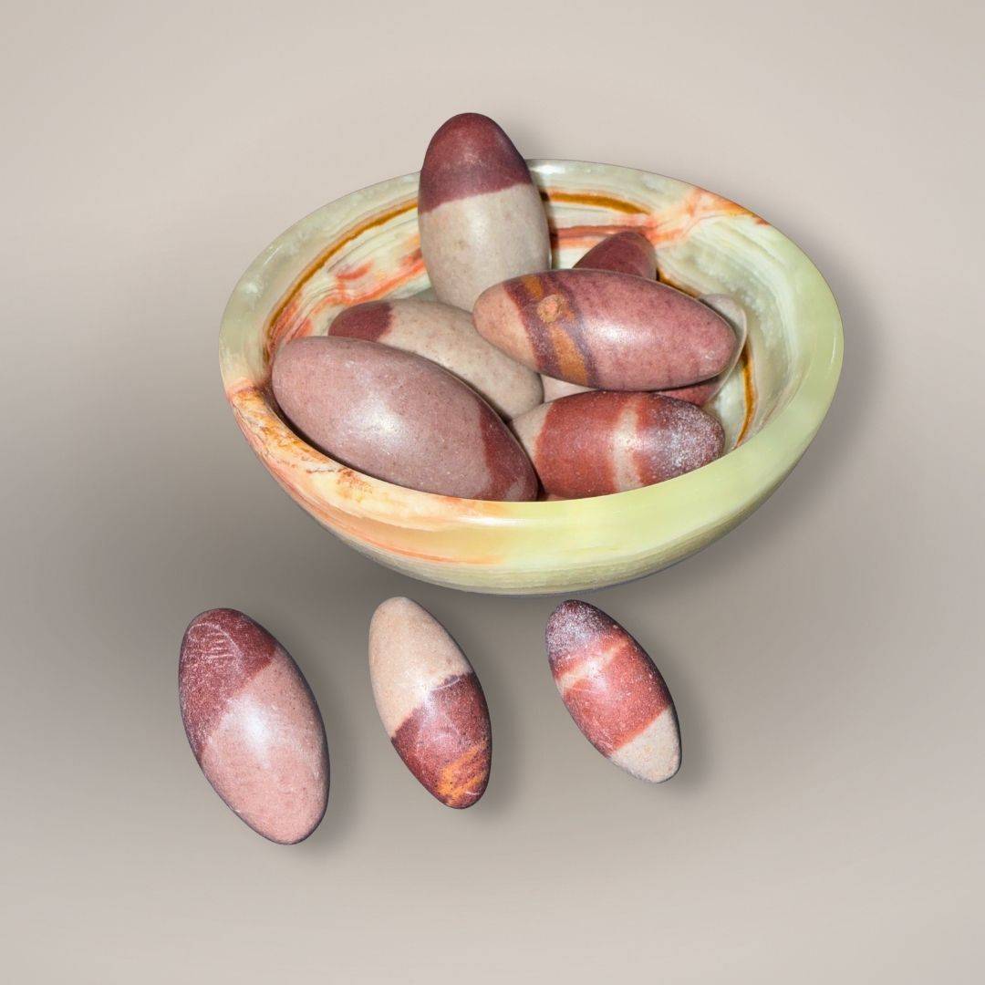 Collection of Shiva Lingam naturally shaped mini stones in an banded calcite bowl, ideal for energy balance and grounding in rock collectibles.