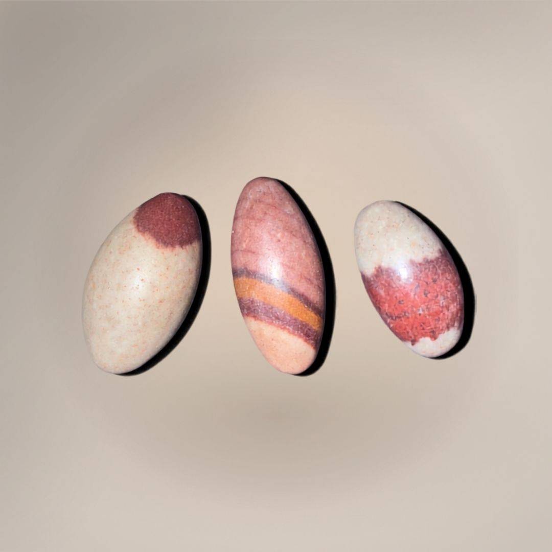 Shiva Lingam Mini naturally shaped stone selection each with distinctive maroon and beige bands, symbolizing sacred balance and vitality in collectible rocks.