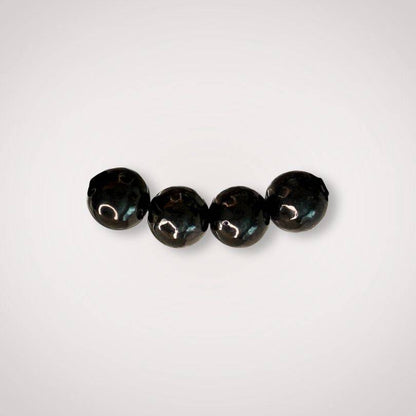 Close-up of four 8mm Shungite beads with a polished finish, ideal for energy clearing and grounding in jewelry making or healing accessories.