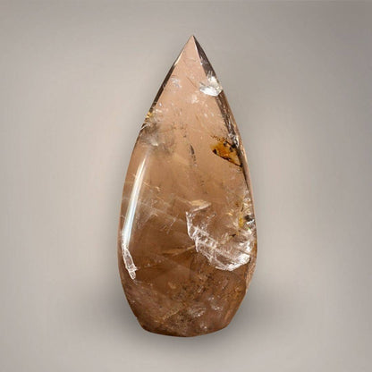 Alternate view of Smoky Quartz flame from Madagascar showing amber-gold coloration, natural internal fractures, and sweeping polished sides.