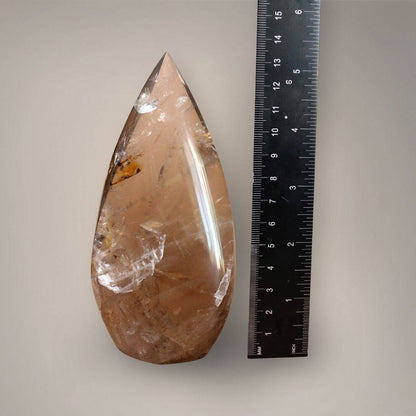 Madagascar Smoky Quartz flame beside a ruler showing its approximately 5.25-inch height, tapered point, and broad lower profile.