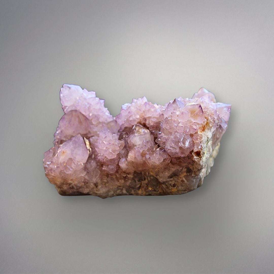 Side view of large Amethyst Spirit Quartz cluster with pale purple crystal points and sparkling druzy overgrowth.