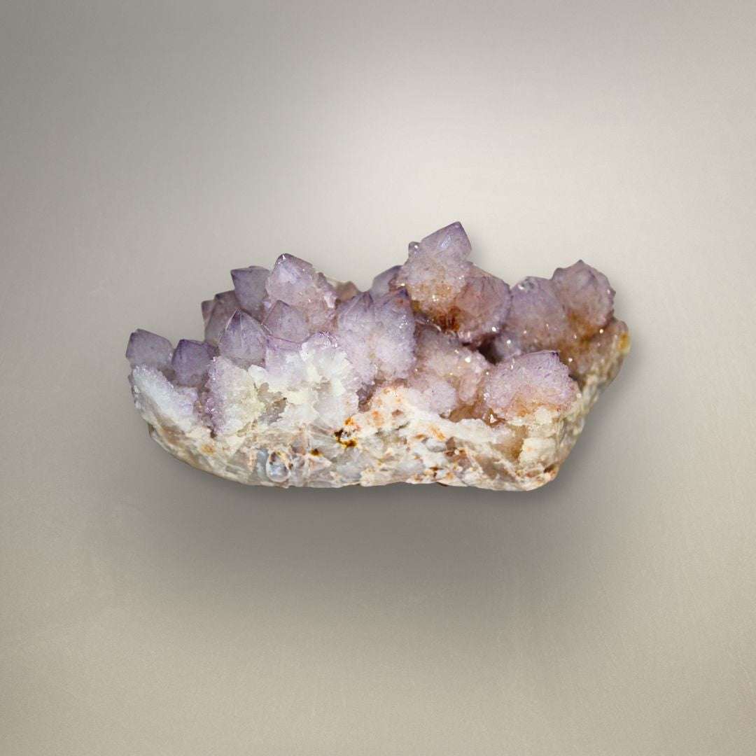 Side view of Amethyst Spirit Quartz cluster with lavender crystal points, white matrix, and warm iron-rich accents.