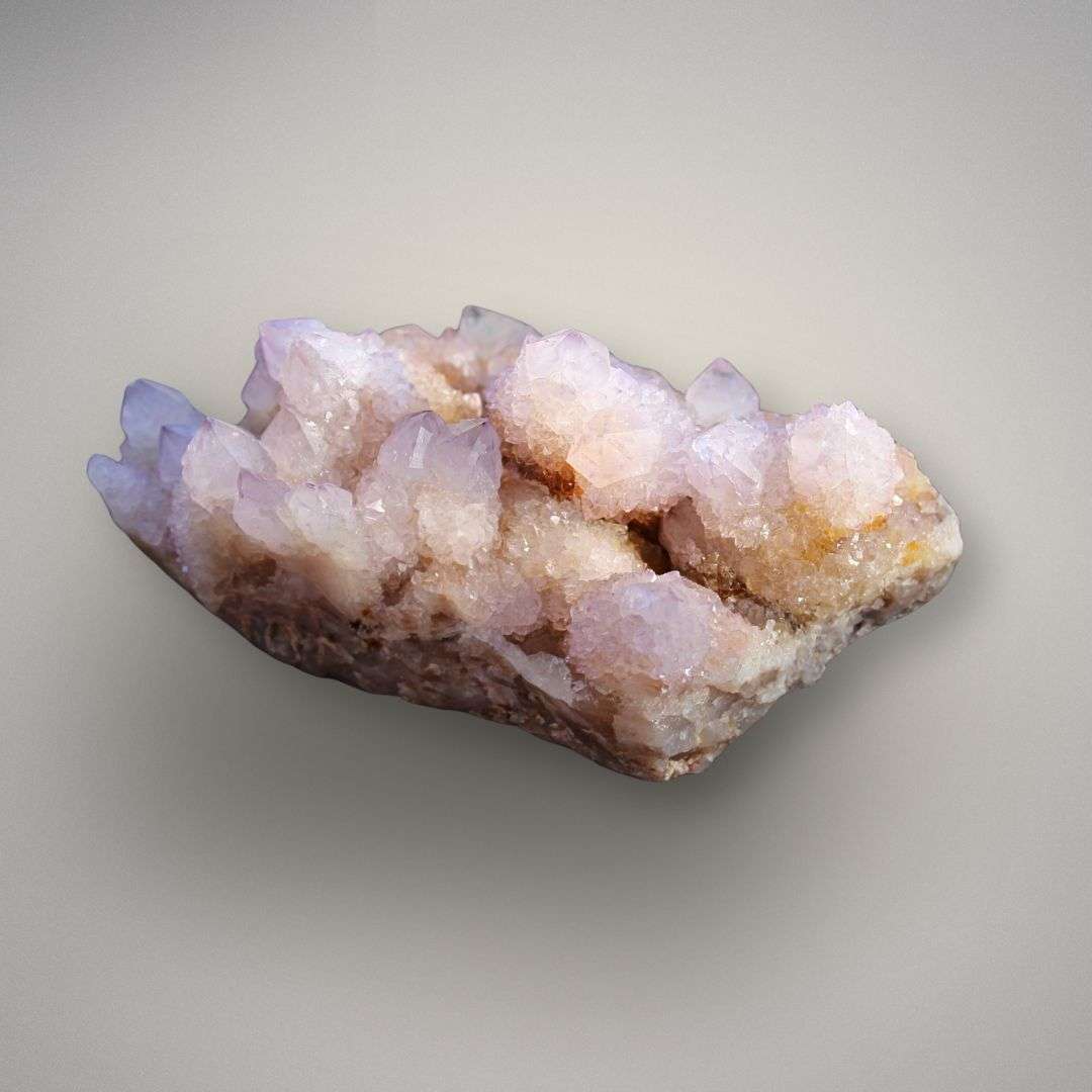 Angled side view of Amethyst Spirit Quartz cluster showing druzy cactus quartz growth and natural display profile.