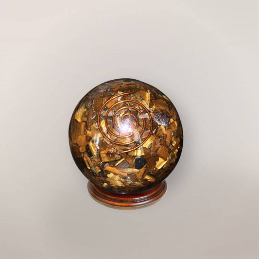 Tiger’s Eye orgonite sphere with Brazilian Tiger’s Eye chips, copper spiral, and wood display stand