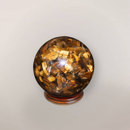 Back view of handmade Tiger’s Eye orgonite sphere showing natural stone chips, copper flakes, and resin texture