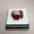 Vanadinite thumbnail specimen with red-orange hexagonal crystal structure and secondary intergrowth in display box