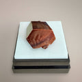 Moroccan Vanadinite thumbnail specimen with dominant red-orange hexagonal crystal on display box