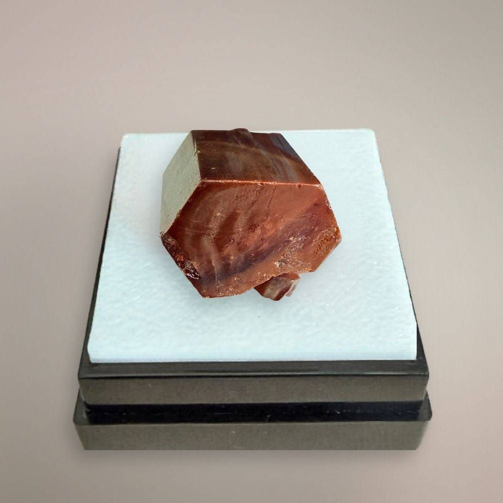 Moroccan Vanadinite thumbnail specimen with dominant red-orange hexagonal crystal on display box