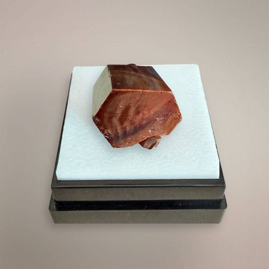 Moroccan Vanadinite thumbnail specimen with dominant red-orange hexagonal crystal on display box