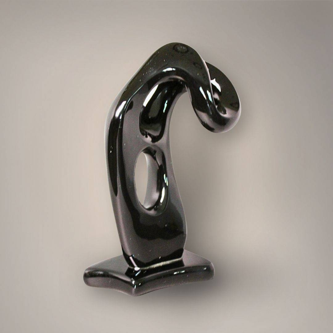 Rear view of the Velvet Rainbow Obsidian figural sculpture showing its glossy black surface, curved profile, and integrated base.