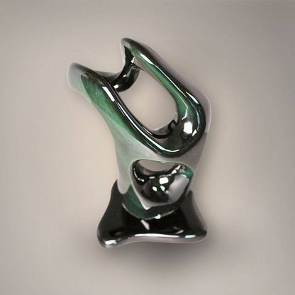 Elevated front view of the Velvet Rainbow Obsidian sculpture highlighting its upper opening, green flash, and polished contours.