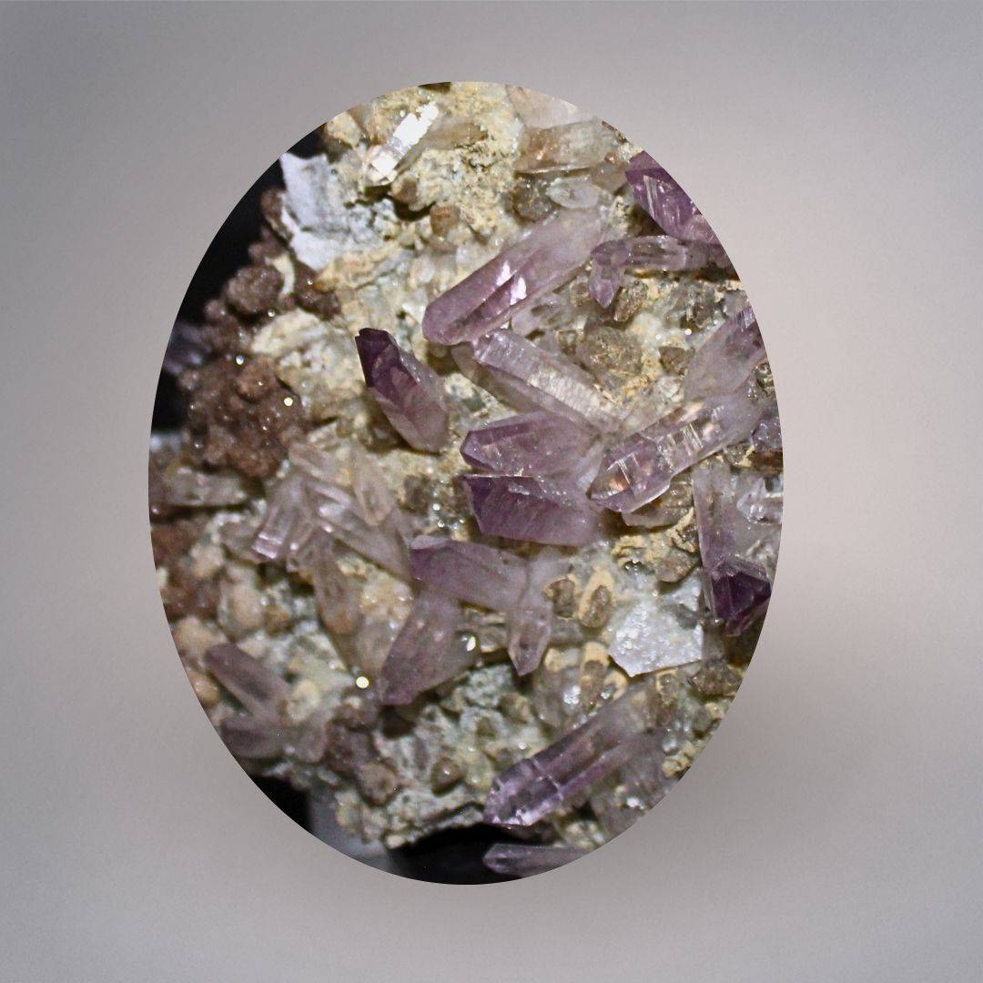 Macro view of Mexico Veracruz Amethyst showing slender lavender-purple quartz points, deeper purple terminations, and matrix detail.
