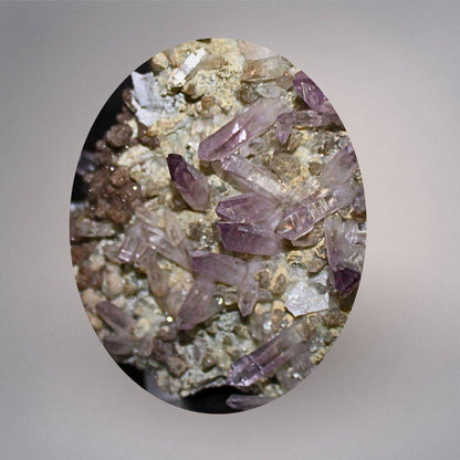 Macro view of Mexico Veracruz Amethyst showing slender lavender-purple quartz points, deeper purple terminations, and matrix detail.