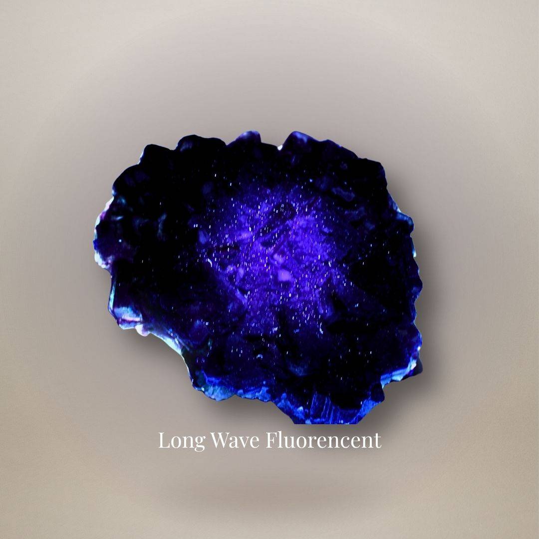 Chinese fluorite cluster showing blue-violet fluorescence under long-wave ultraviolet illumination.