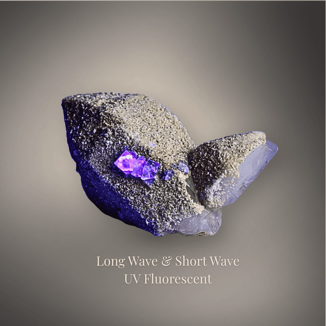 UV view of quartz specimen showing fluorescent fluorite and scheelite under ultraviolet illumination.